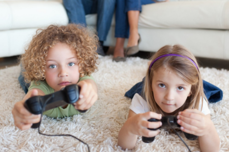 two children holding video game controllers